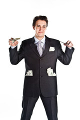 young businessman in a dark suit surrounded by flying dollars