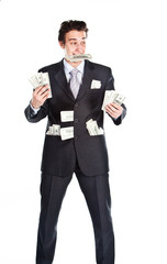 young businessman in a dark suit surrounded by flying dollars