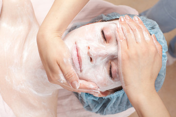 Fototapeta premium Beautiful woman with facial mask getting beauty treatment at sal