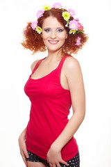 smiling ginger woman in red cloth with colorful flowers in hair