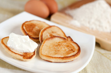 Home pancakes with sour cream, flour and eggs