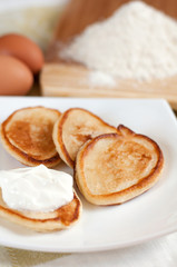 Home pancakes with sour cream, flour and eggs