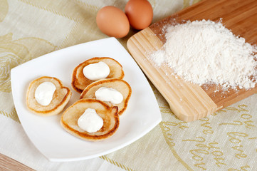 Home pancakes with sour cream, flour and eggs