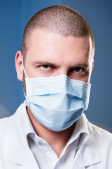 Portrait of a serious confident doctor in mask. Concept of coronavirus or covid-19, corona virus or covid19