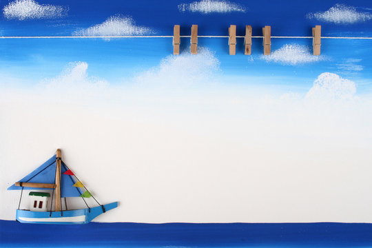 Picture Board with Wooden Paper Clip on Blue Sky, Ocean and Boat