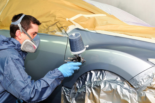 Worker Painting A Car.