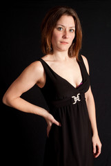 Fototapeta premium Lovely brunette woman in little black dress