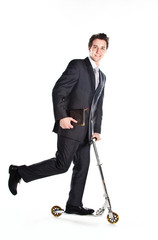 successful man in business suit who rides a scooter