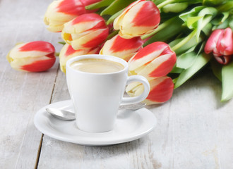 Fototapeta na wymiar Coffee cup and red tulips