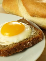 Sunny side up egg on a slice of bread