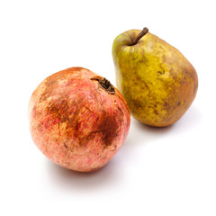 pomegranates and pear on a white