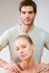 Obraz na płótnie Canvas man massaging woman's shoulders