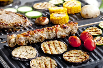 meat skewer and vegetables on electric grill