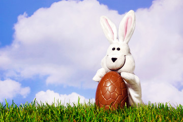 Easter bunny holding a chocolate egg