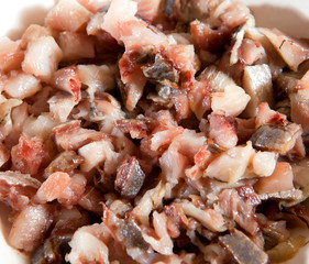 Meat of fish is cut small for salad