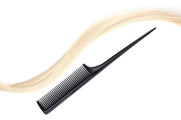 Shiny blond hair and comb isolated on white
