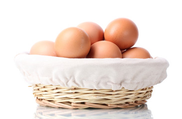 brown eggs in basket isolated on white