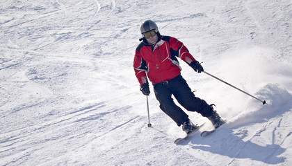 man down the slope on skis