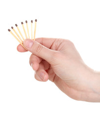 Matches in hand isolated on white