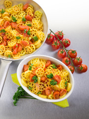pasta with fresh tomatoes over steel background