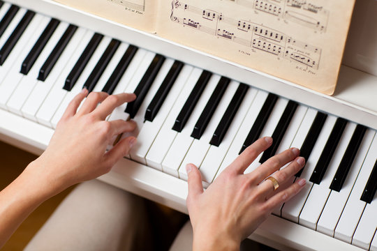 Playing Piano (shallow DOF; color toned image)