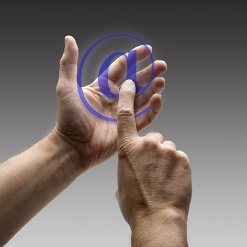 Two hands holding a at symbol.