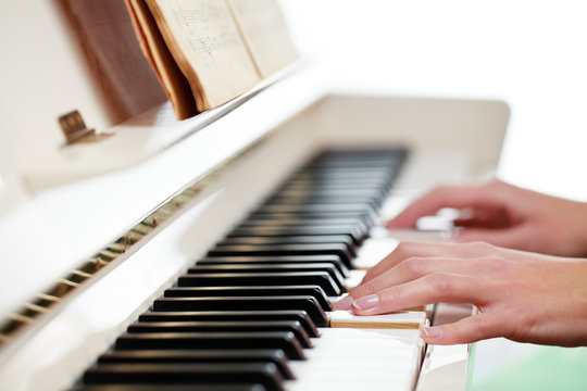 Playing Piano (shallow DOF; color toned image)