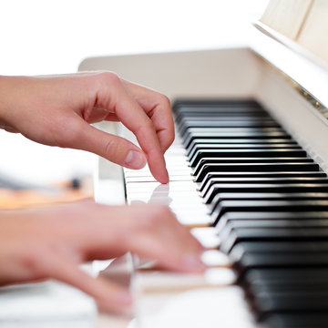 Playing Piano (shallow DOF; color toned image)