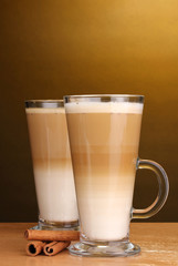 Fragrant сoffee latte in glass cup and cinnamon