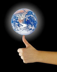 Planet earth on finger.Elements of this image furnished by NASA