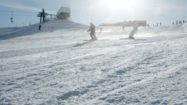 Skiers and Snowboarders going down the slope