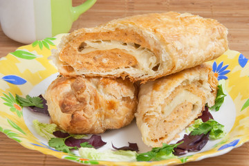 pie with fish mince filling, roll of puff pastry on plate