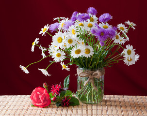 A bouquet of spring flowers in a glass