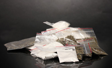 Cocaine and marihuana in packages on grey background