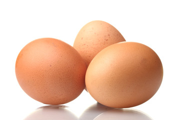 three brown eggs isolated on white