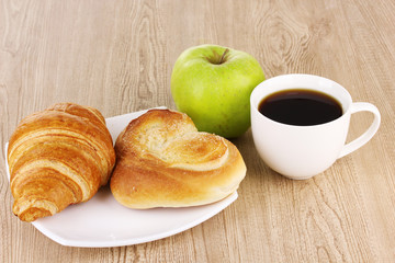Classical breakfast. Coffee with croissant and bun
