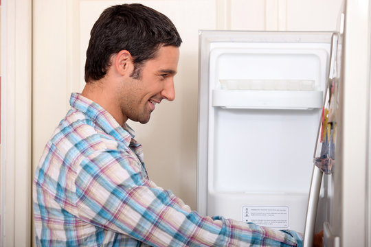 Man Opening Fridge Door