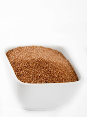 sugar in a white bowl on white background