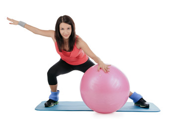 Attractive young female with fitness ball in stretching