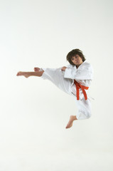 boy practicing karate on white background