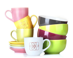 bright empty bowls, cups and plates isolated on white