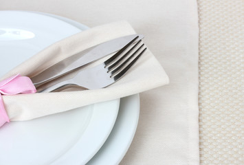 Table setting with fork, knife, plates, and napkin