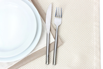 Table setting with fork, knife, plates, and napkin