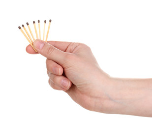 Matches in hand isolated on white