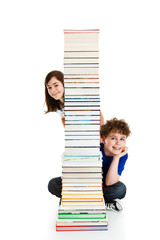 Kids behind pile of books isolated on white background