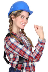 Female construction worker showing her strength