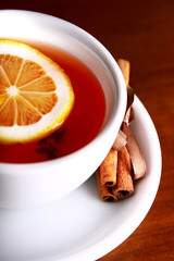 cup of hot tea on brown background