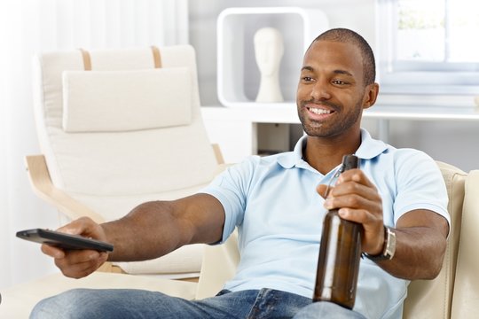 Man with beer and remote control