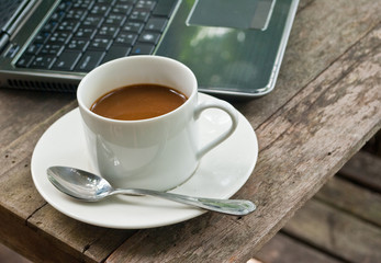 Coffee cup and laptop for business.