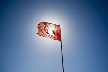 Red flag covers the sun's rays